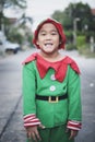 Asian children wearing red and green suit of santa claus theme standing outdoor