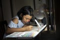 Asian children writing and using smartphone to doing homework Royalty Free Stock Photo