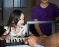 Asian children young kids playing keyboard piano at home Royalty Free Stock Photo