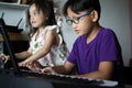 Asian children young kids playing keyboard piano at home Royalty Free Stock Photo