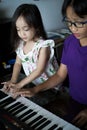 Asian children young kids playing keyboard piano at home Royalty Free Stock Photo