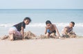 Asian chindren playing with the sand on the beach. Royalty Free Stock Photo