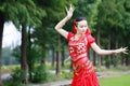 Asian Chinese beauty belly dancer dancing on grass Royalty Free Stock Photo