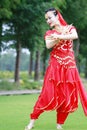 Asian Chinese beauty belly dancer dancing on lawn Royalty Free Stock Photo