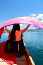 Asian Chinese beauty in red dress at Yunnan Lugu lake, on a boat