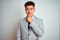 Asian chinese businessman wearing suit and tie standing over isolated yellow background looking confident at the camera with smile Royalty Free Stock Photo