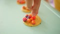 Close-up of asian chinese child playing with playdoh and making tiny objects