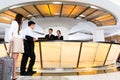 Asian Chinese couple arriving at hotel front desk Royalty Free Stock Photo