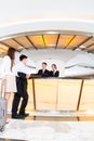 Asian Chinese couple arriving at hotel front desk Royalty Free Stock Photo