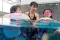 Asian Chinese family playing at the outdoor swimming pool Royalty Free Stock Photo