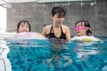 Asian Chinese family playing at the outdoor swimming pool Royalty Free Stock Photo