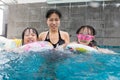 Asian Chinese family playing at the outdoor swimming pool Royalty Free Stock Photo