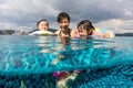 Asian Chinese family playing at the outdoor swimming pool Royalty Free Stock Photo