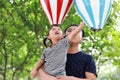 Asian Father embrace hug daughter dad love girl child play have fun in a park outdoor summer day family activity happy childhood Royalty Free Stock Photo