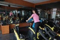 Asian chinese Fitness young woman on gym bike spinning Royalty Free Stock Photo