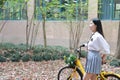 Relax Asian Chinese pretty girls wear student suit in school enjoy free time ride bike in nature spring garden Royalty Free Stock Photo
