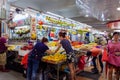 An Asian Chinese fruit seller serving customers at her fruit stall at the Ang Mo Kio wet market in Singapore, Southeast Asia