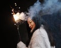 Asian chinese Girl holding sparkler firework with hand. Brunette, looking Royalty Free Stock Photo