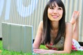 Asian Chinese Girl using laptop and thinking Royalty Free Stock Photo