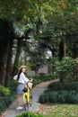Asian Chinese Happy cute adorable lovely student ride yellow shared bicycle in a park outdoor in summer Royalty Free Stock Photo