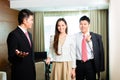Asian Chinese hotel manager presenting suite