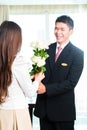 Asian Chinese hotel manager welcoming VIP guest