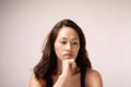 Asian chinese lady in deep thought with pink background