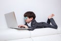 Asian Chinese little boy playing laptop on the couch Royalty Free Stock Photo