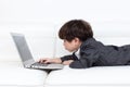 Asian Chinese little boy playing laptop on the couch Royalty Free Stock Photo