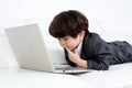 Asian Chinese little boy playing laptop on the couch Royalty Free Stock Photo