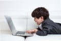 Asian Chinese little boy playing laptop on the couch Royalty Free Stock Photo