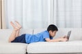 Asian Chinese little boy using laptop on the sofa Royalty Free Stock Photo