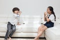 Asian Chinese little brother and sister playing tin can phone Royalty Free Stock Photo