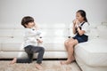 Asian Chinese little brother and sister playing tin can phone Royalty Free Stock Photo