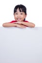 Asian Chinese little girl behind a blank white board Royalty Free Stock Photo