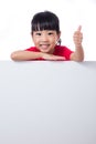 Asian Chinese little girl behind a blank white board Royalty Free Stock Photo