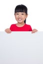 Asian Chinese little girl behind a blank white board Royalty Free Stock Photo