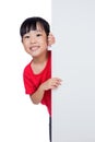 Asian Chinese little girl behind a blank white board Royalty Free Stock Photo