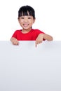 Asian Chinese little girl behind a blank white board Royalty Free Stock Photo