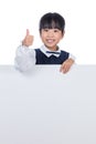 Asian Chinese little girl behind a blank white board Royalty Free Stock Photo