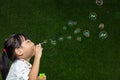 Asian Chinese little girl blowing soap bubbles Royalty Free Stock Photo