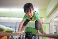 Asian Chinese little girl climbing on parallel bars Royalty Free Stock Photo