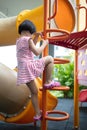 Asian Chinese little girl climbing stepladder