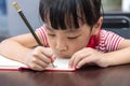Asian Chinese little girl doing homework Royalty Free Stock Photo