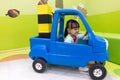 Asian Chinese little girl driving toy car Royalty Free Stock Photo