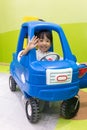 Asian Chinese little girl driving toy car Royalty Free Stock Photo
