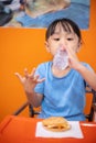 Asian Chinese little girl eating burger Royalty Free Stock Photo