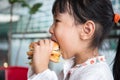 Asian Chinese little girl eating burger Royalty Free Stock Photo