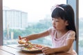 Asian Chinese little girl eating pizza pepperoni Royalty Free Stock Photo