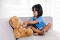 Asian Chinese little girl examination teddy bear with stethoscope Royalty Free Stock Photo